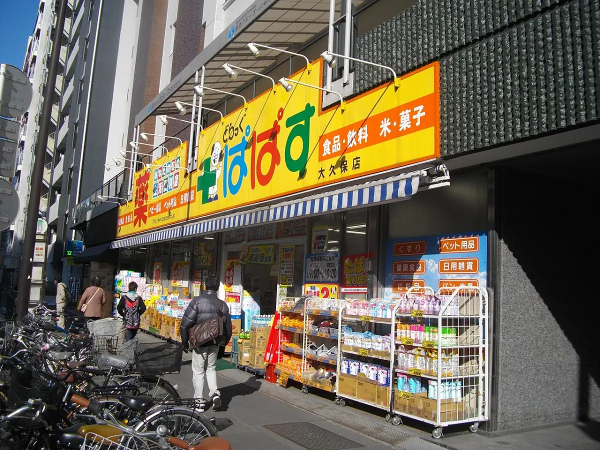 Drug Papasu drugstore in Tokyo with daily goods displayed on shelves outside the entrance