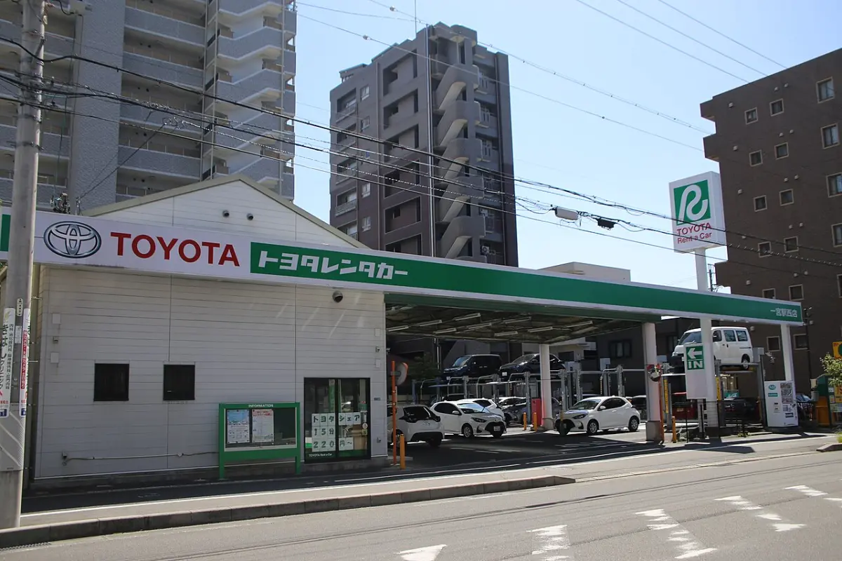 Toyota Rent a Car branch with its green sign and rental cars parked outside