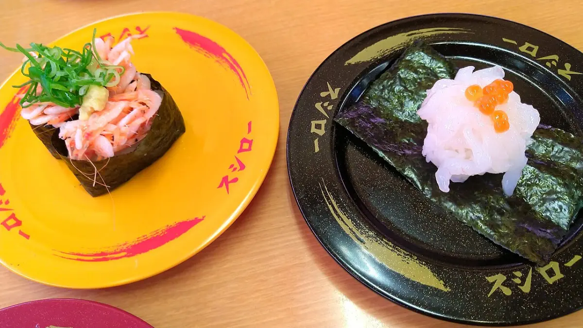 Sakura shrimp gunkan and white shrimp sushi on Sushiro-branded plates