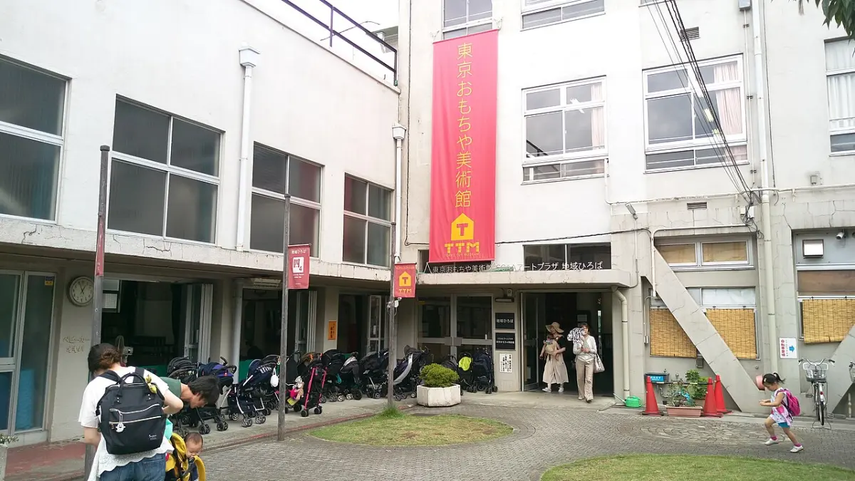 Entrance of Tokyo Toy Museum in a former school building in Yotsuya, with strollers parked outside