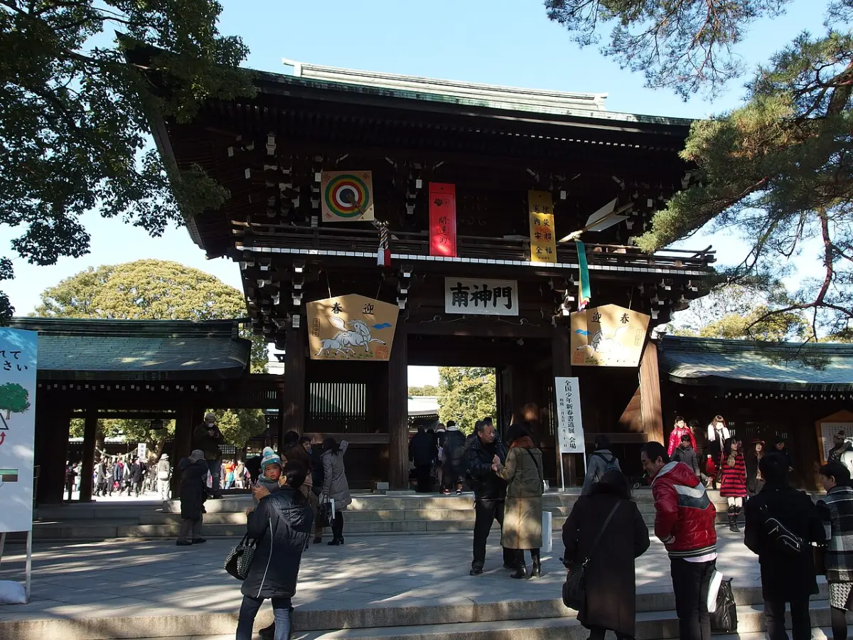 Visitors at the south gate of Meiji Jingu, decorated with large New Year ema boards