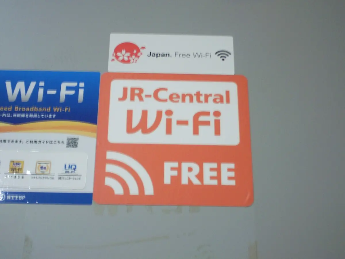 Free Wi-Fi stickers at a Tokaido Shinkansen station, including the Japan Free Wi-Fi logo