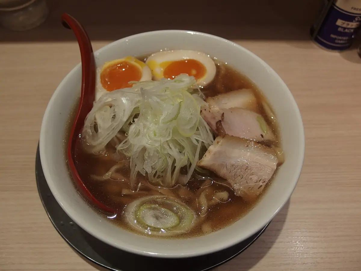 Bowl of shoyu ramen with soft-boiled egg and pork slices at Tokyo Ramen Street in Tokyo Station