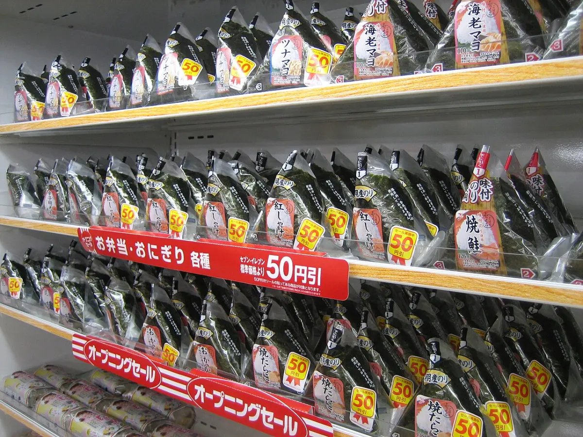 Shelves of wrapped onigiri rice balls at a 7-Eleven in Japan