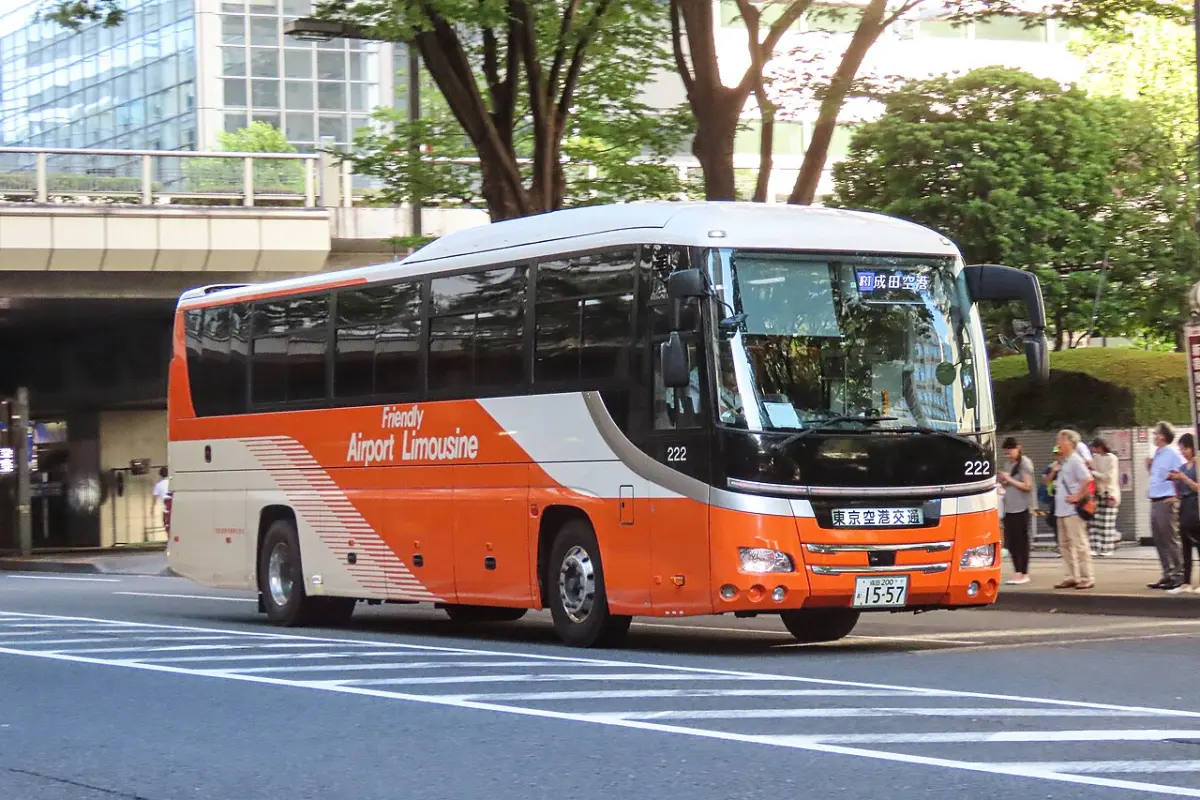 Orange and white Airport Limousine bus to Narita at a stop in Shinjuku