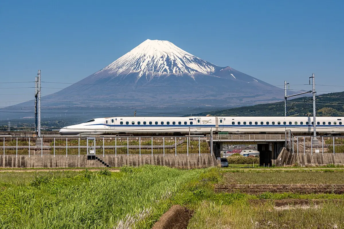 N700S Tokaido Shinkansen passing in front of snow-capped Mount Fuji near Higashi-Tagonoura