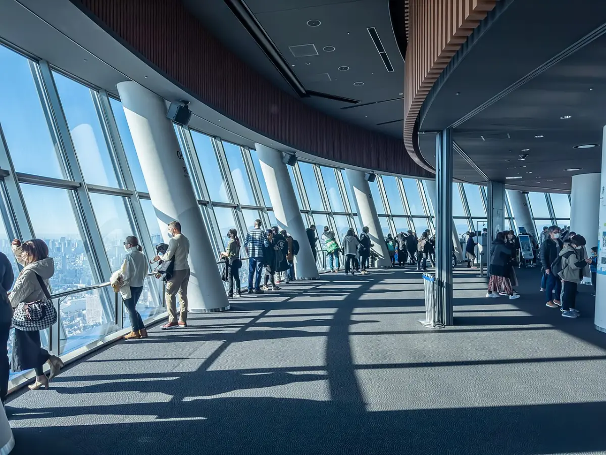 Visitors at the floor-to-ceiling windows of the Tembo Deck inside Tokyo Skytree