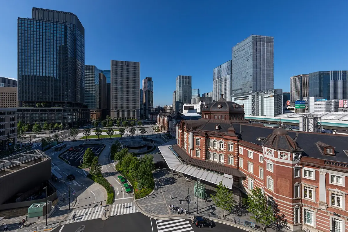 Red-brick Tokyo Station Marunouchi building and Marunouchi Central Plaza under a blue sky